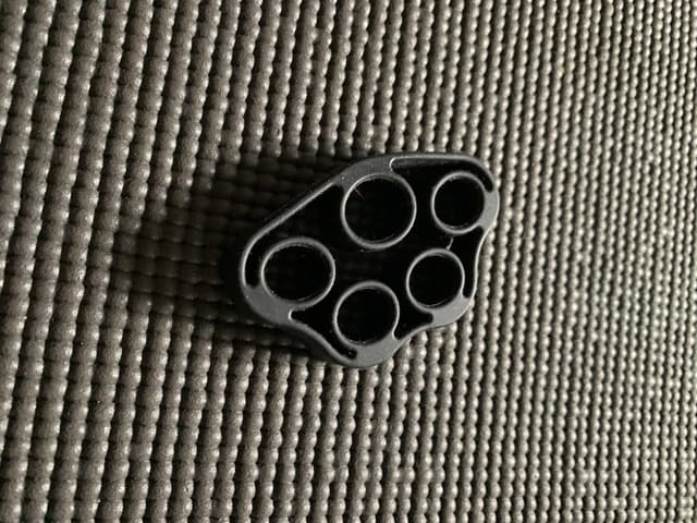 Black plastic five-hole cable/cord organizer